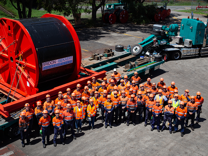 An image of the Bridon-Bekaert Ropes Group Australia Team standing in front of one of our large wire rope reels destined for a cable run conveyor. 